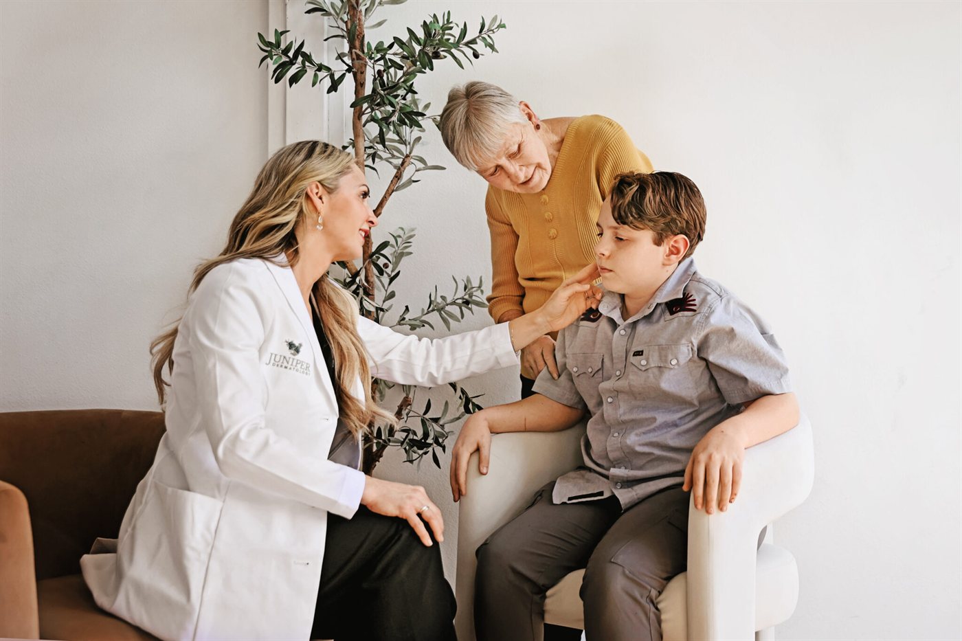 A Juniper Dermatology clinician talking with a patient and family member during a vitiligo consultation in Bend, Oregon