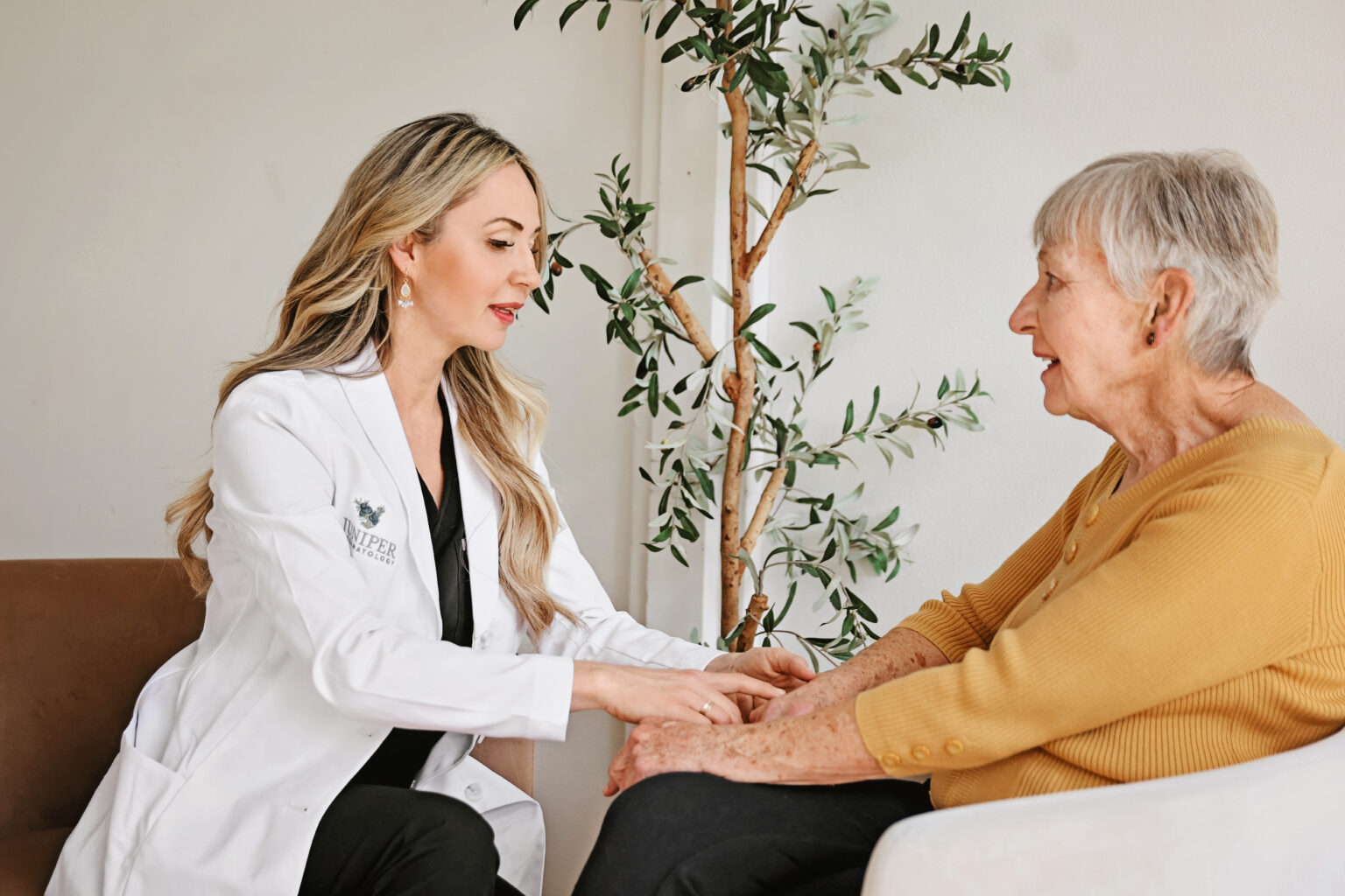 A Juniper Dermatology dermatologist examining an older patient's skin during a shingles evaluation in Bend, Oregon