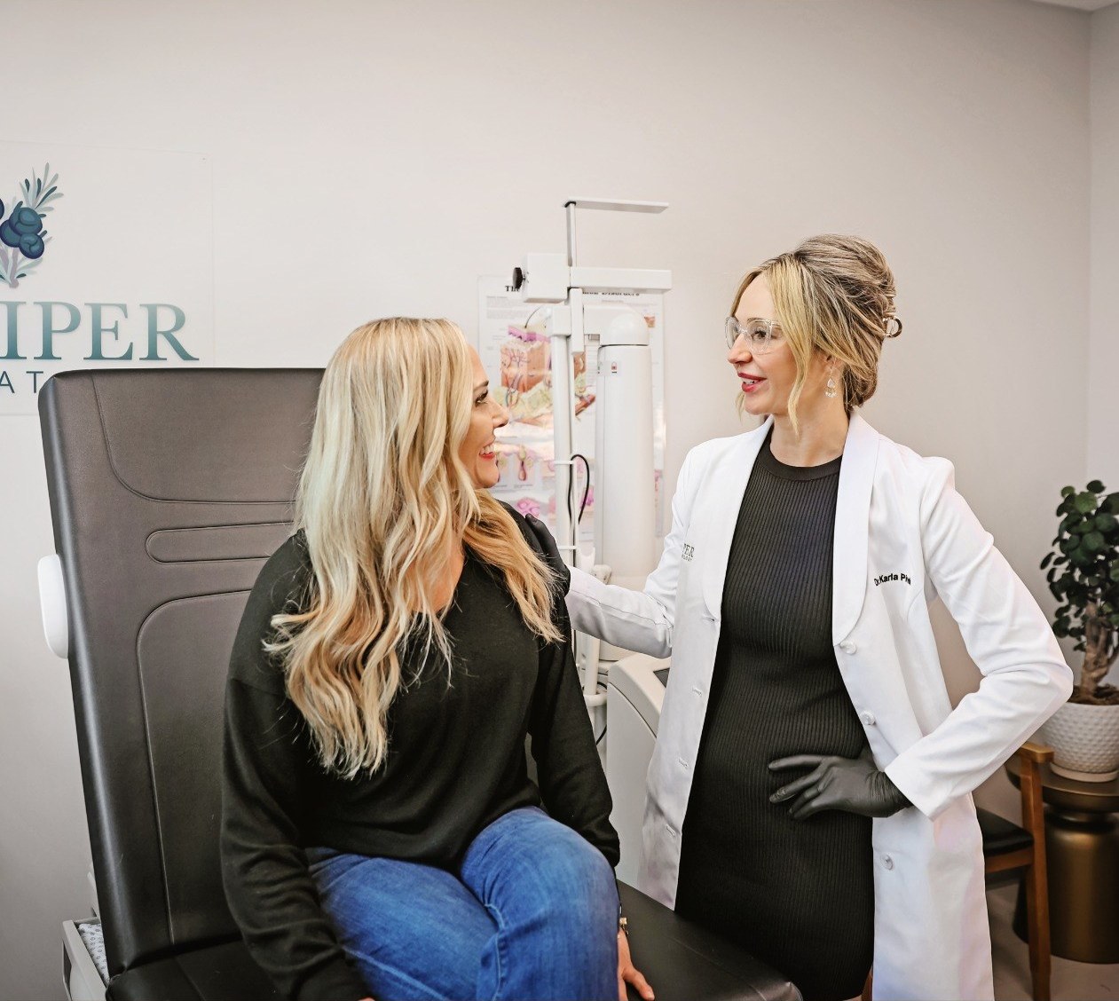 Dr. Karla Pivik consulting with a patient in the exam room at Juniper Dermatology in Bend, Oregon