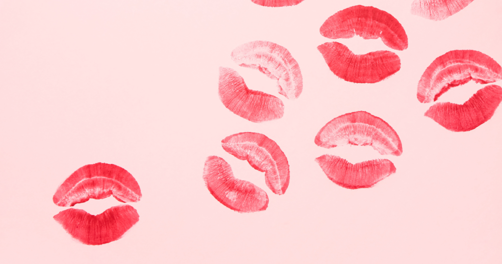 Lipstick marks on a pink background.