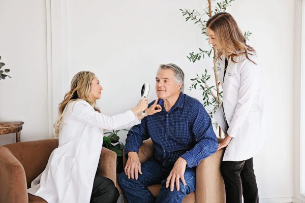 Providers consulting with male patient for melasma treatment in Bend, OR